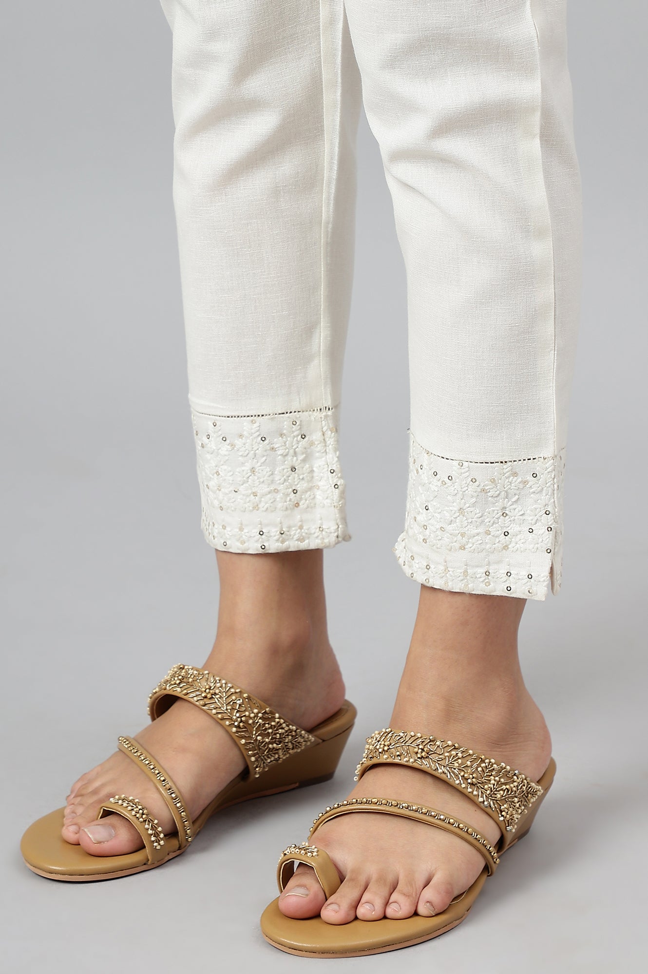 Ecru Slim Pants With Embroidered Hem