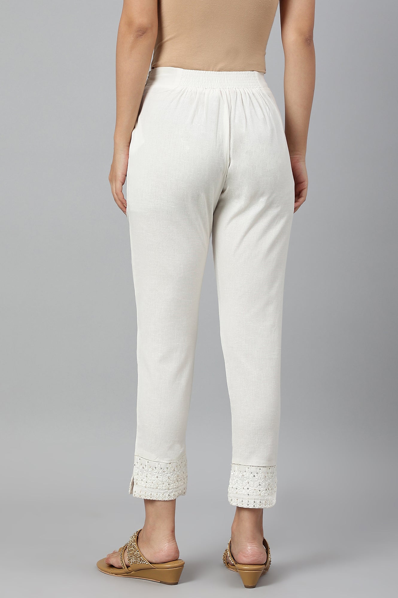 Ecru Slim Pants With Embroidered Hem